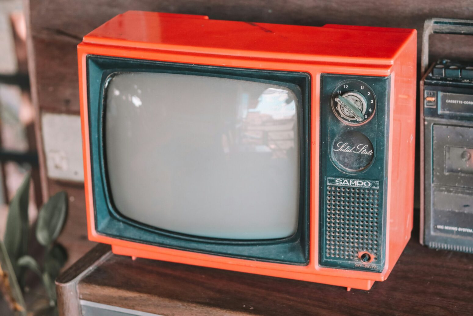 A very old television in a red frame