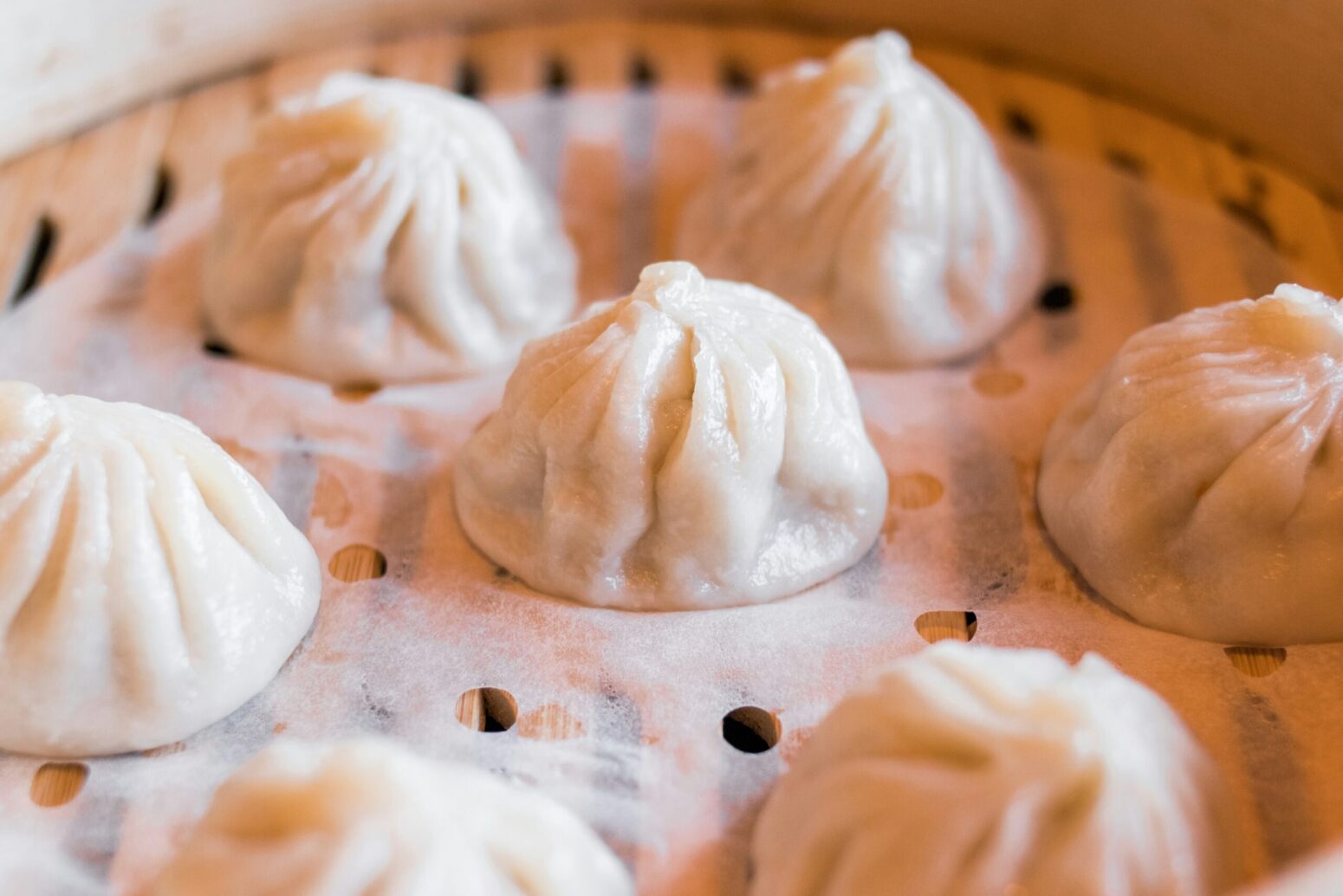 white steamed dumplings in a steamer basket