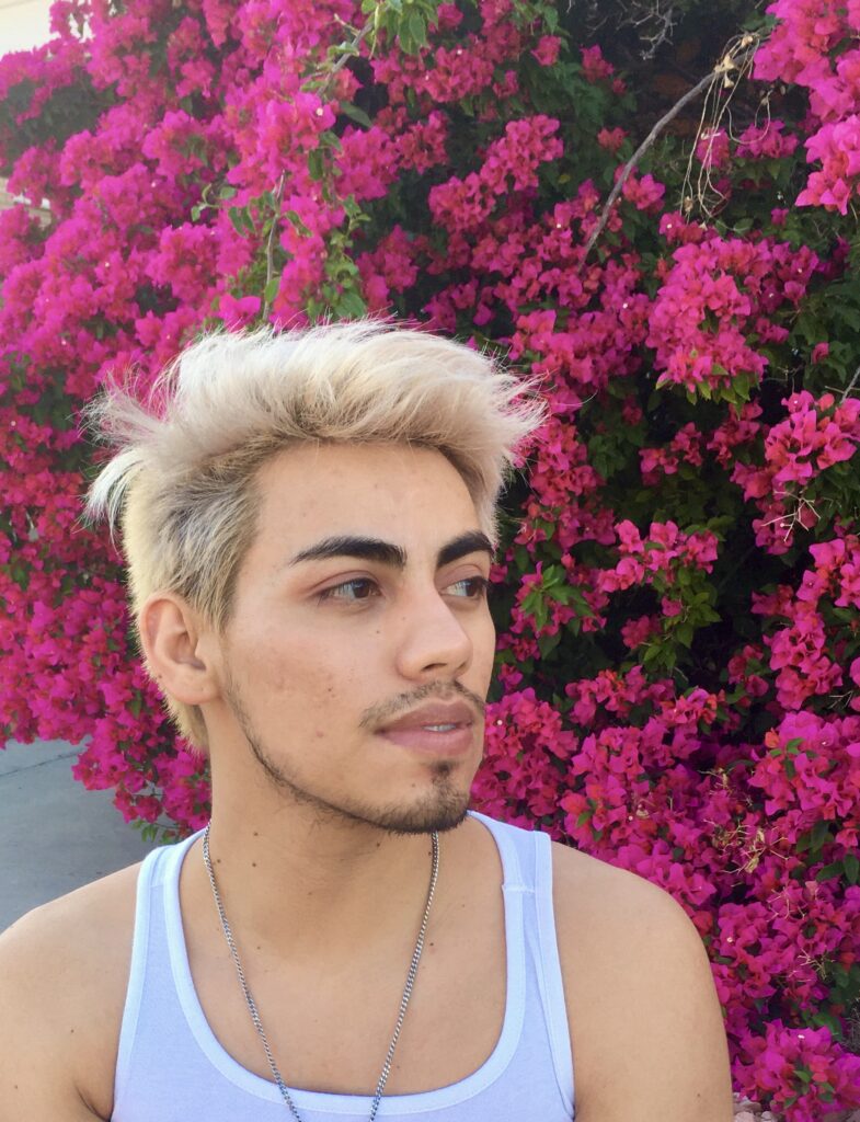 photo of author against a backdrop of pink flowers