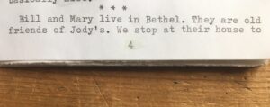A typed page of a zine, with three asterisks and then "Bill and Mary live in Bethel. They are old friends of Jody's. We stop at their house to" and the numeral 4. A small woodgrain table strip below.