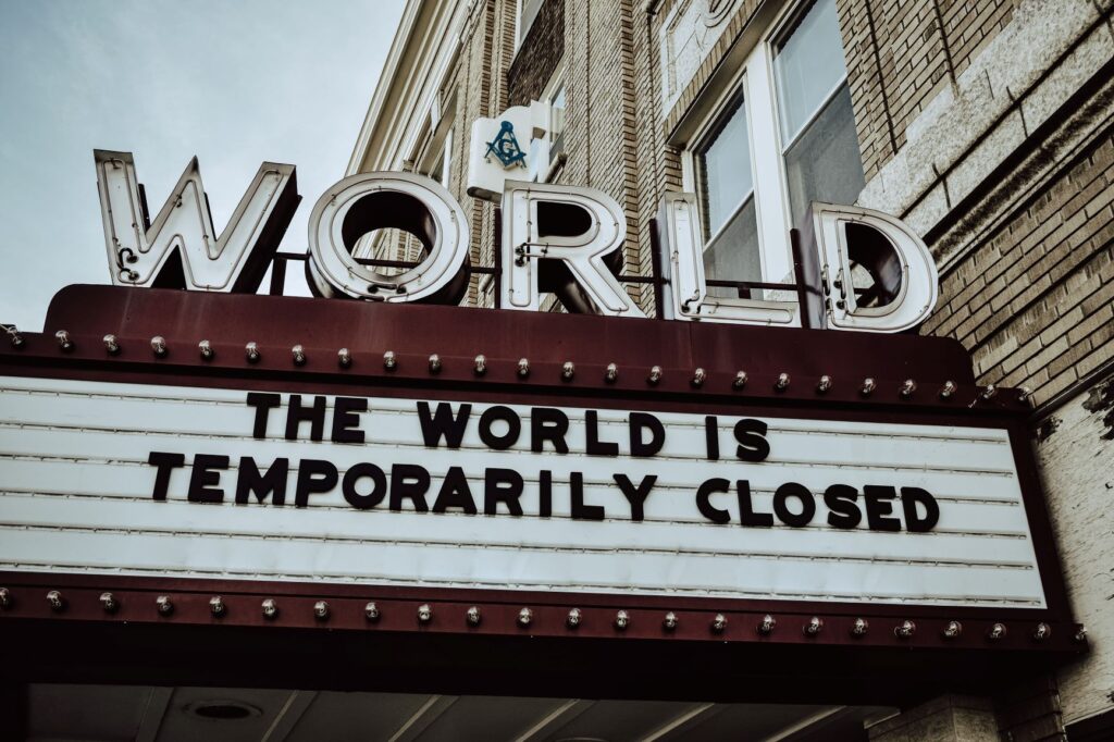 photo of cinema marquee that says, "The World Is Temporarily Closed"