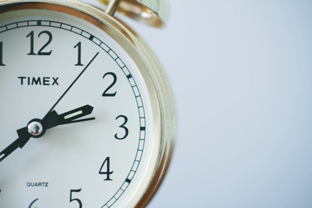 Photo of an enlarged analog clock against a white background