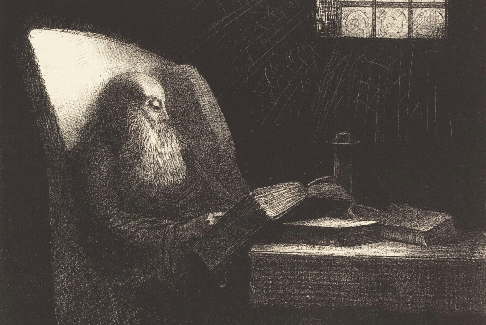 A photo of "Le Liseur (The Reader)," a lithograph by Odilon Redon from 1892. The piece depicts a grayscale drawing of an old man, sitting in an arm chair and reading a thick book by the light of a window.