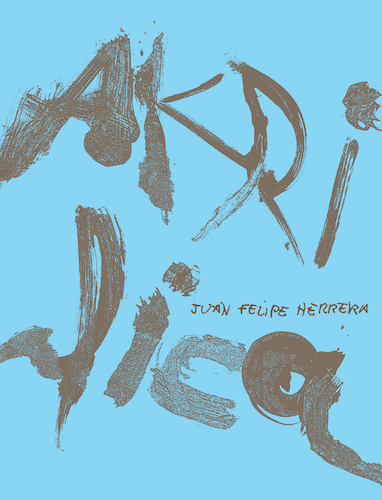 An image of Juan Felipe Herrera's book, Akrílica. The book is sky blue with the title written in large, gray paint at the center. 