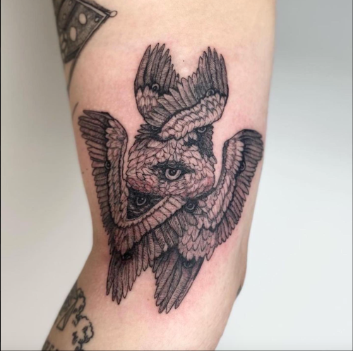 A tattoo of a seraphim on an inner elbow