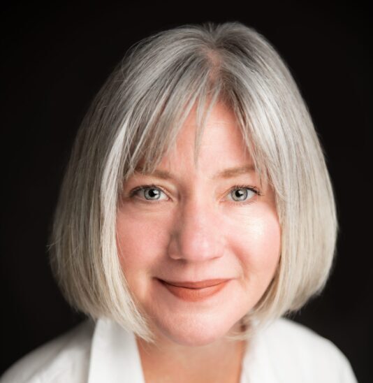 Rebecca Lindenberg, a white woman with a gray bob, smiles at the camera.
