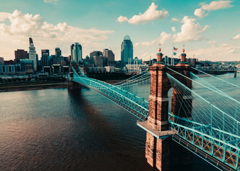 The Roebling Bridge spans the Ohio River towards high rise buildings in Cincinnati.