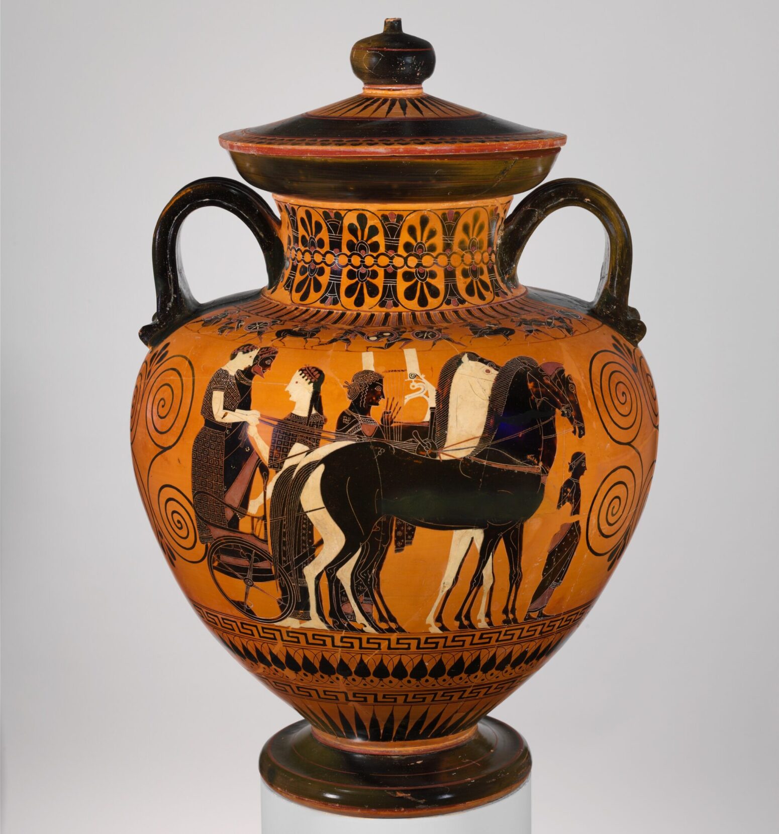 Grecian amphora attributed to Exekias, a holding of the Metropolitan Museum of Art. The jar is decorated in black and tan, with images of horses, people, as well as decorative swirls and other motifs. It has two handles.