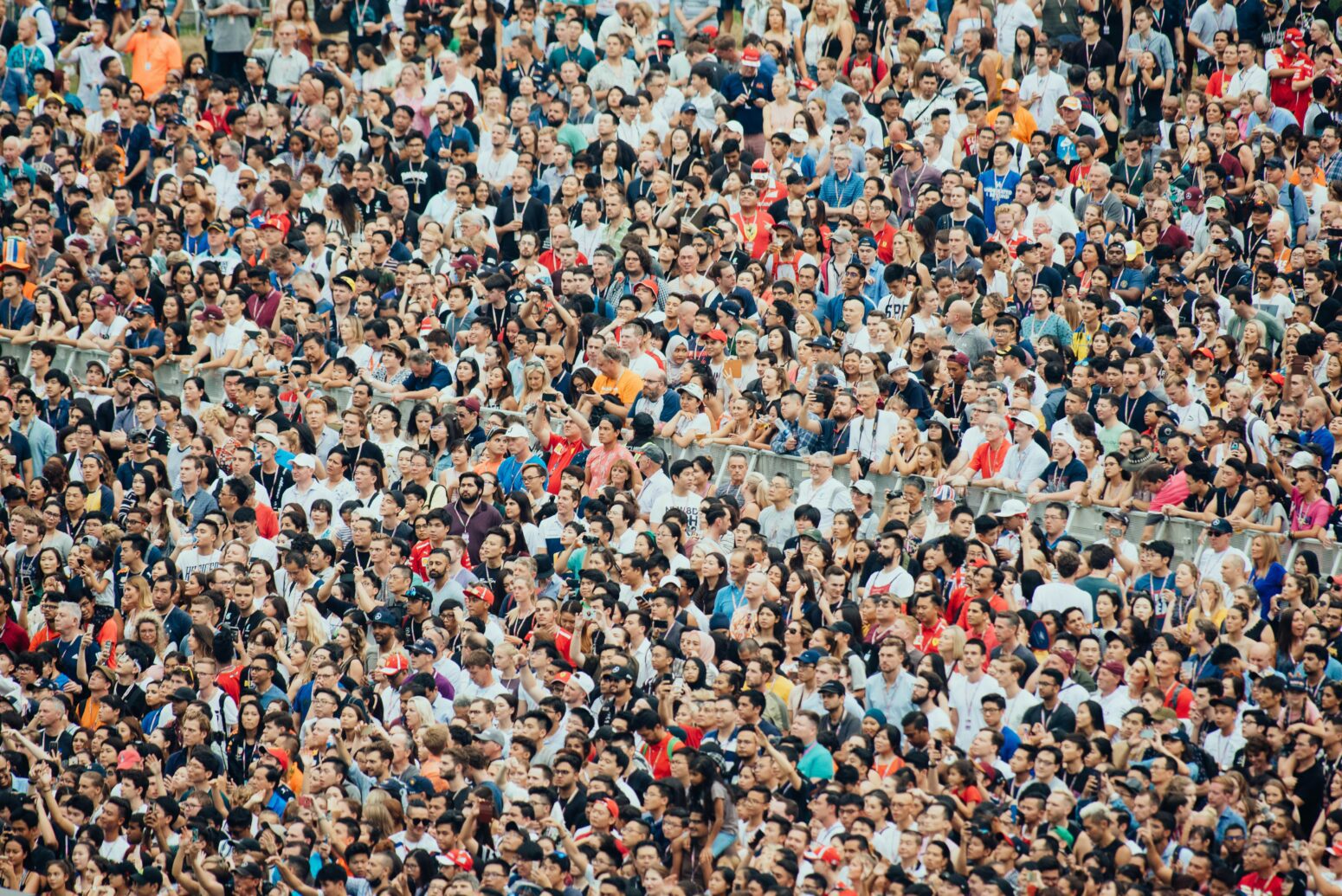 A massive crowd of people of all different races and genders fills the entire frame.