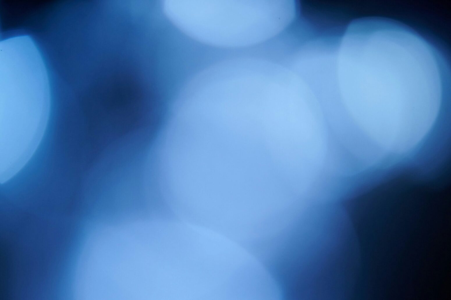 Scattered blue light against a black background.