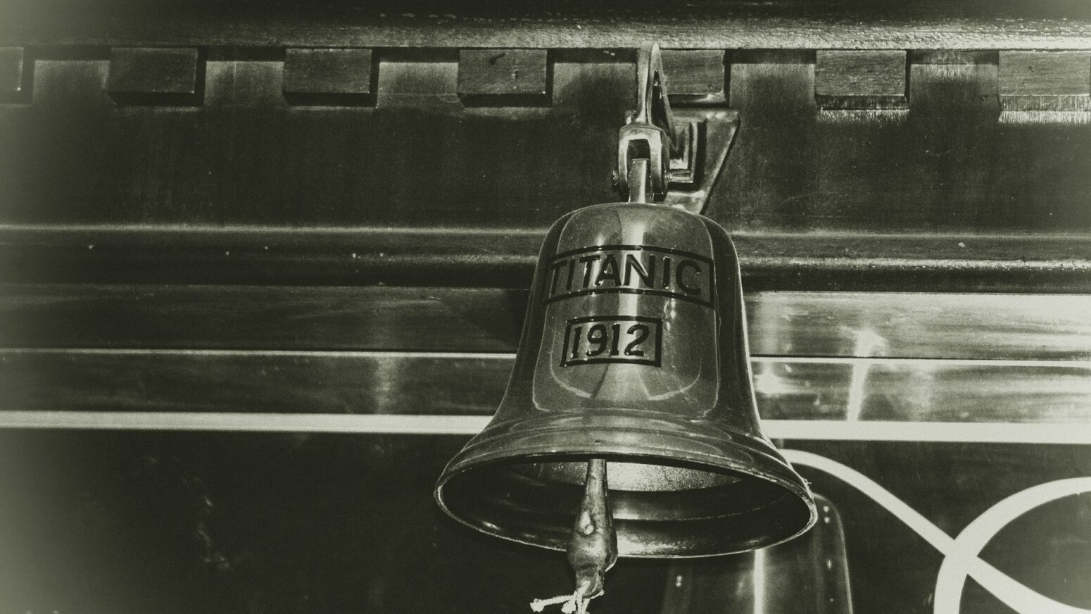 A close up of a bell aboard the Titanic, reading: "Titanic 1912"