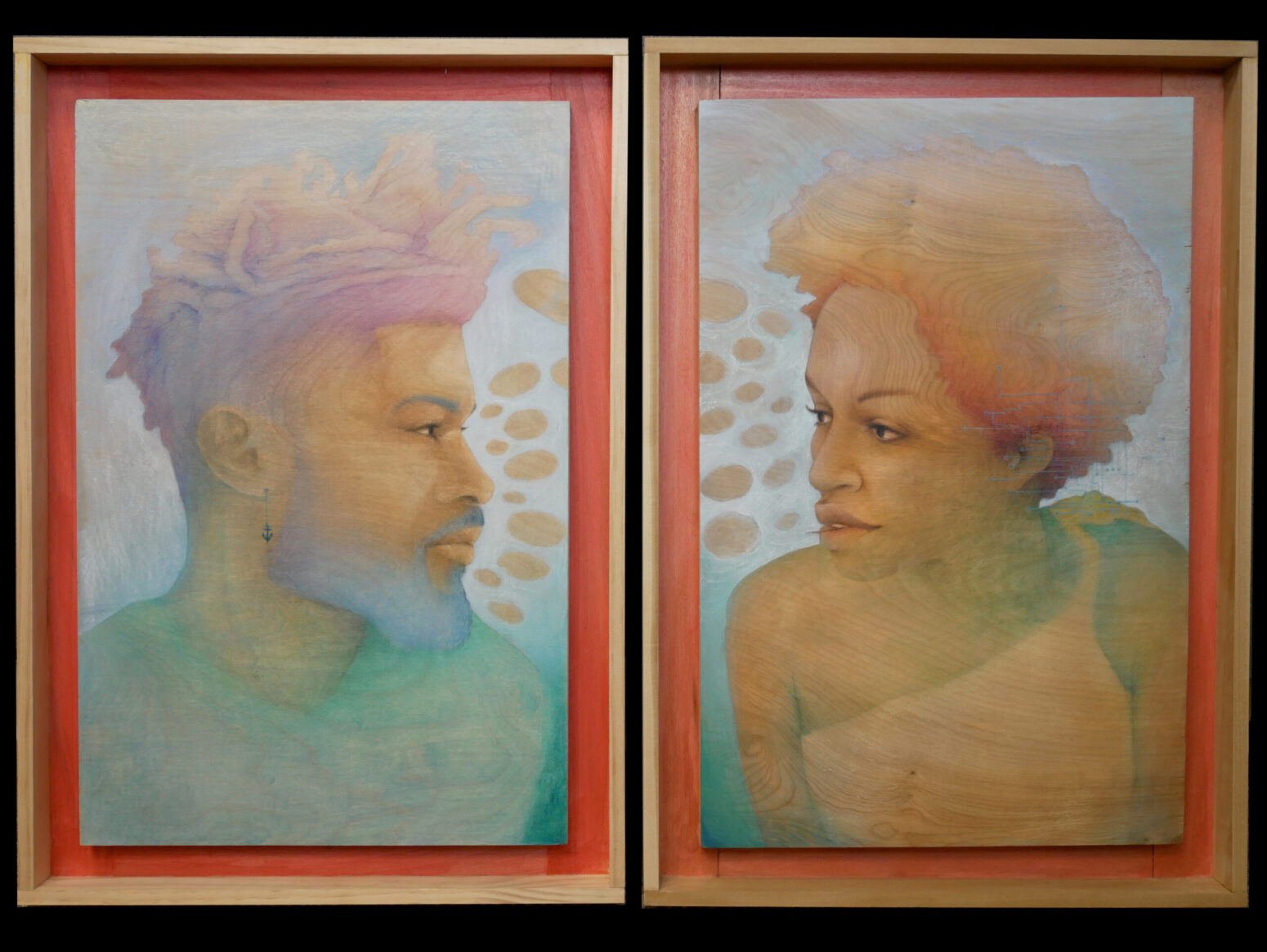 Two wooden frame that hold two paintings surrounded by a red border. On the left, a black man with a blue beard and blue-and-purple locs looks to the right. He wears a teal shirt. On the right, a black woman with a red-and-orange afro looks to the left. She wears an asymmetric, orange shirt. The background of both paintings is blue with gray ellipses near their faces.