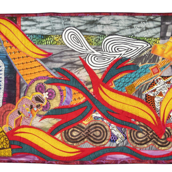 On the bottom left of the quit is a golden fan that alternates between two patterns. Above it is what looks like a tall, glass jar burning incense. Four yellow-and-red leaves take up a lot of space on the scene. Three black-and-white-striped, tear-drop-shaped cut-outs overlap each other on the top middle. Behind them appears to be a wall with a gray, stone pattern. The bottom of the quilt is lined with a purple fabric.