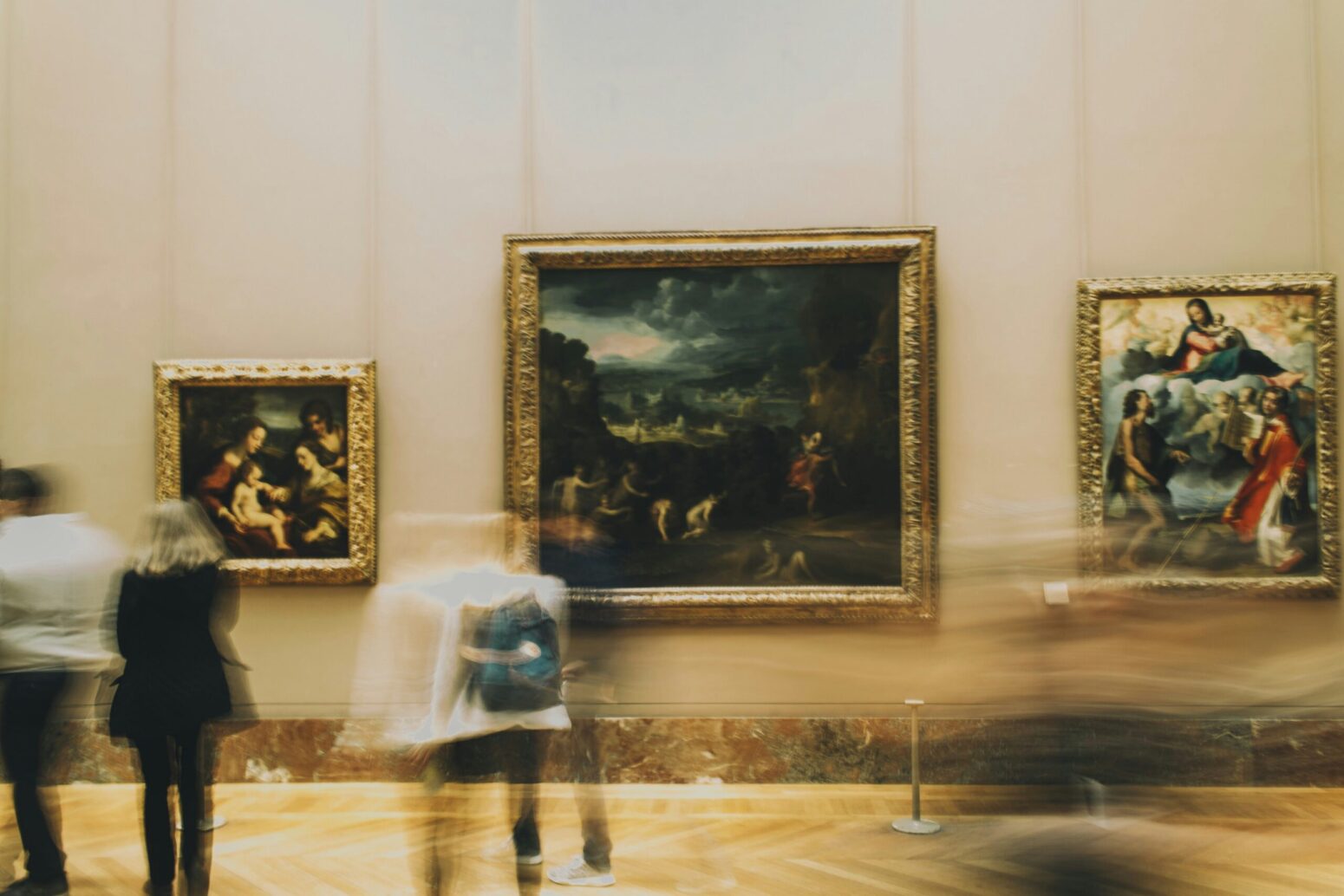A blurry photo of people walking around an art museum.