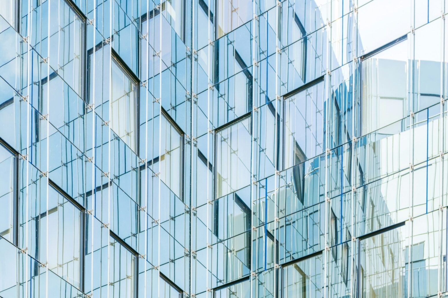 The wall of a geometric, layered, glass building