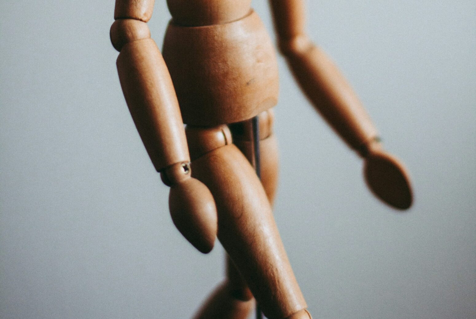 The bottom-half of a small, wooden, posing doll