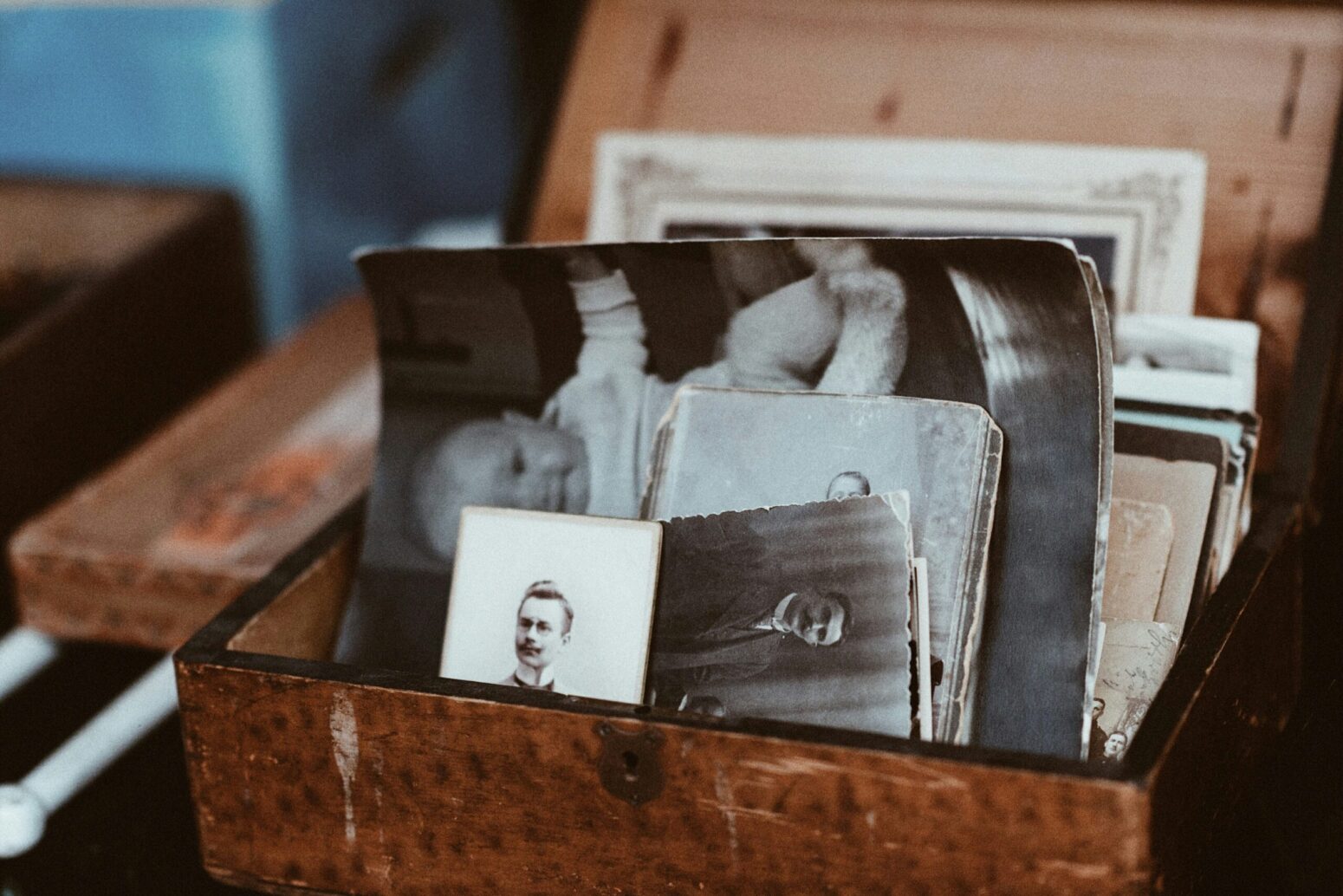 A brown box full of old, black-and-white photos.