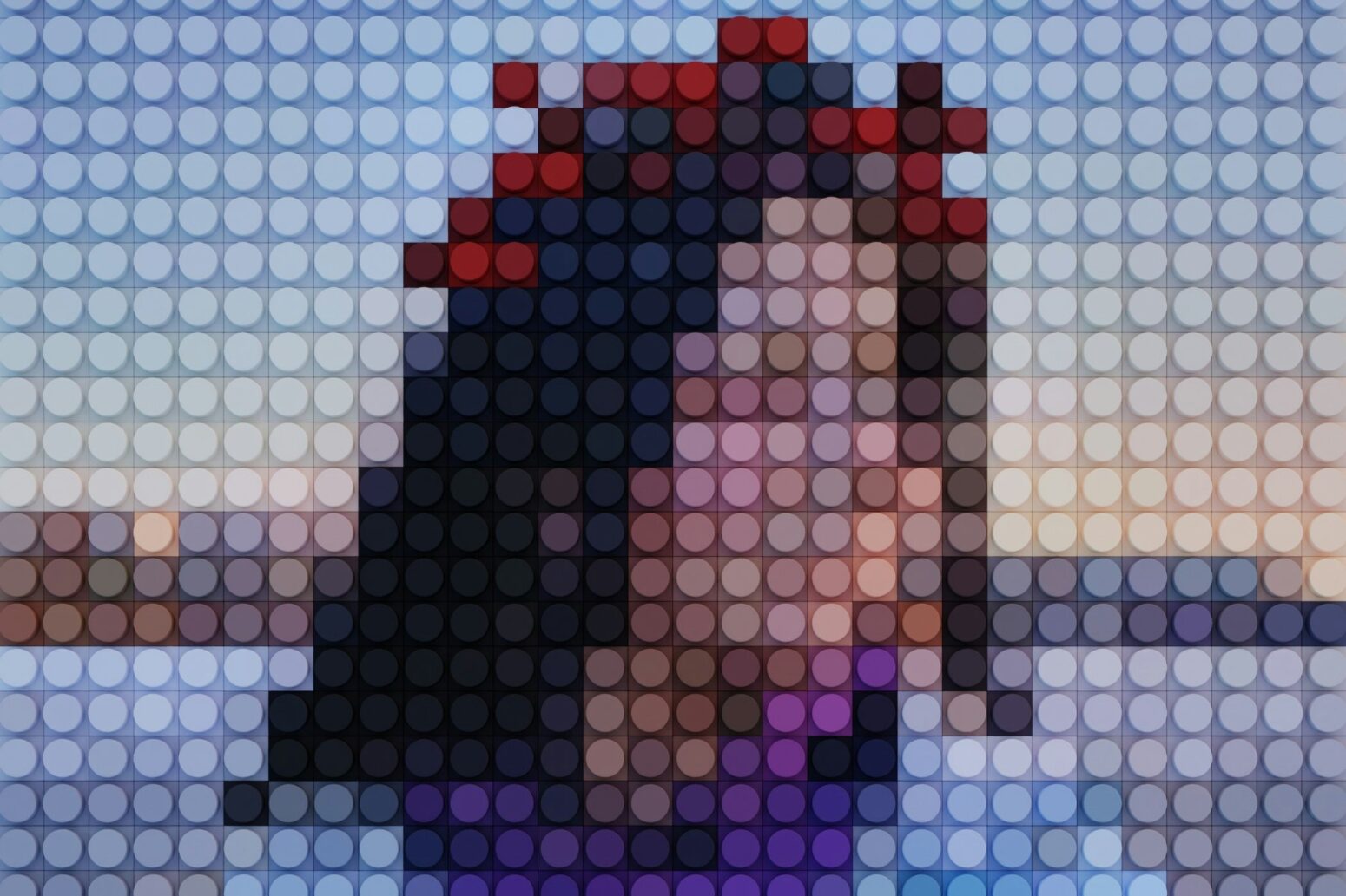 A picture of a woman with shoulder-length brown hair, but the photo is entirely pixelated with circles.