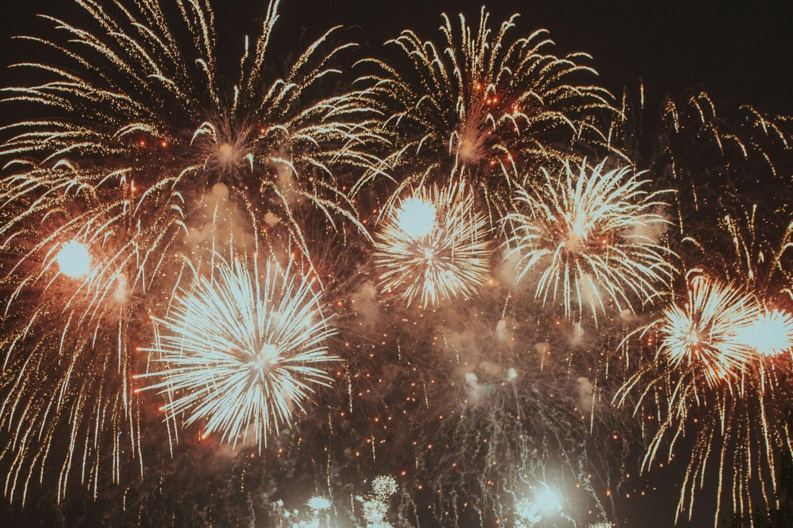 Golden fireworks lighting up a black sky