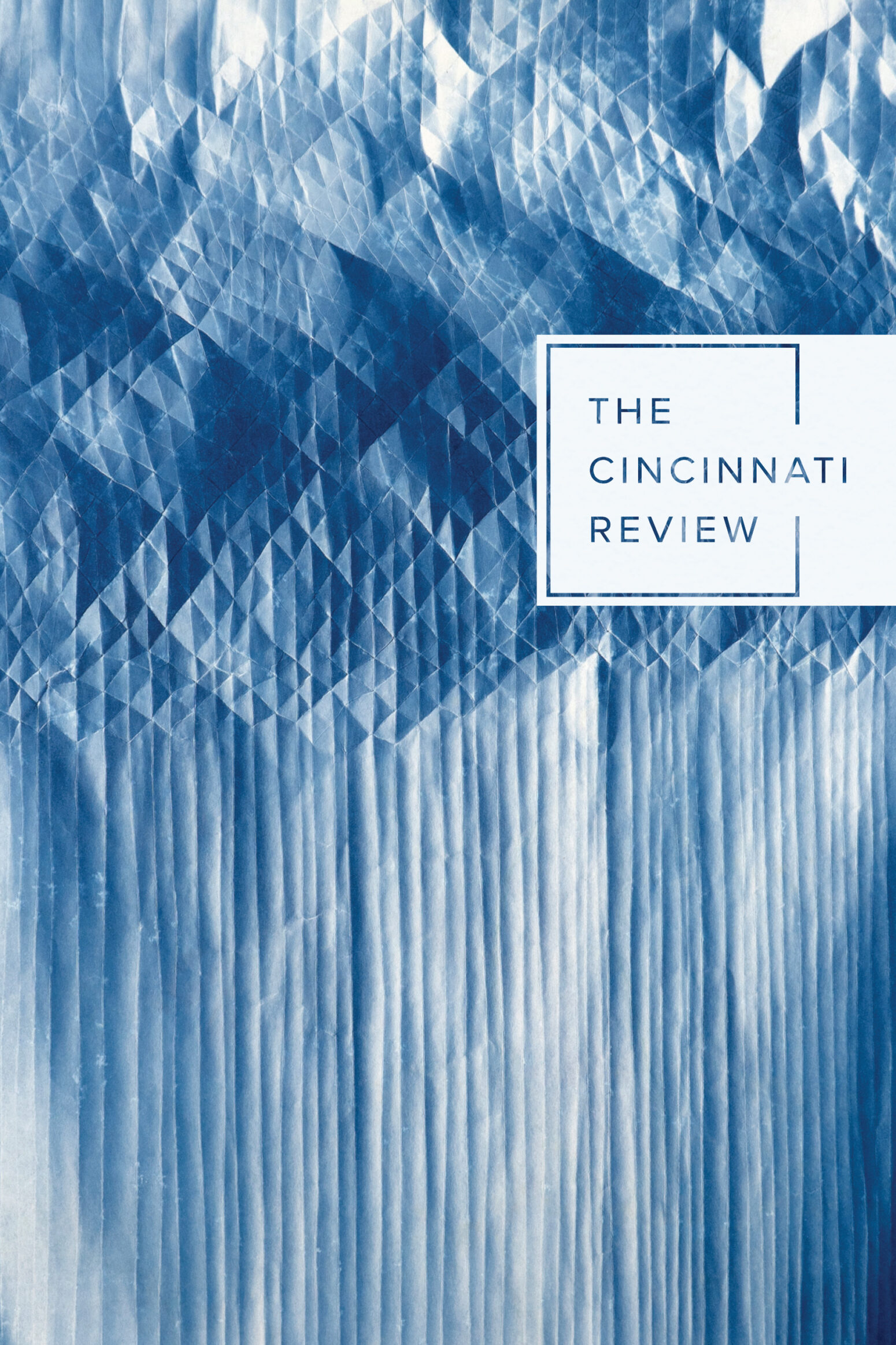 Cover of issue 23.1. A folded cyanotype showing intricate patterns of diamonds and lines.