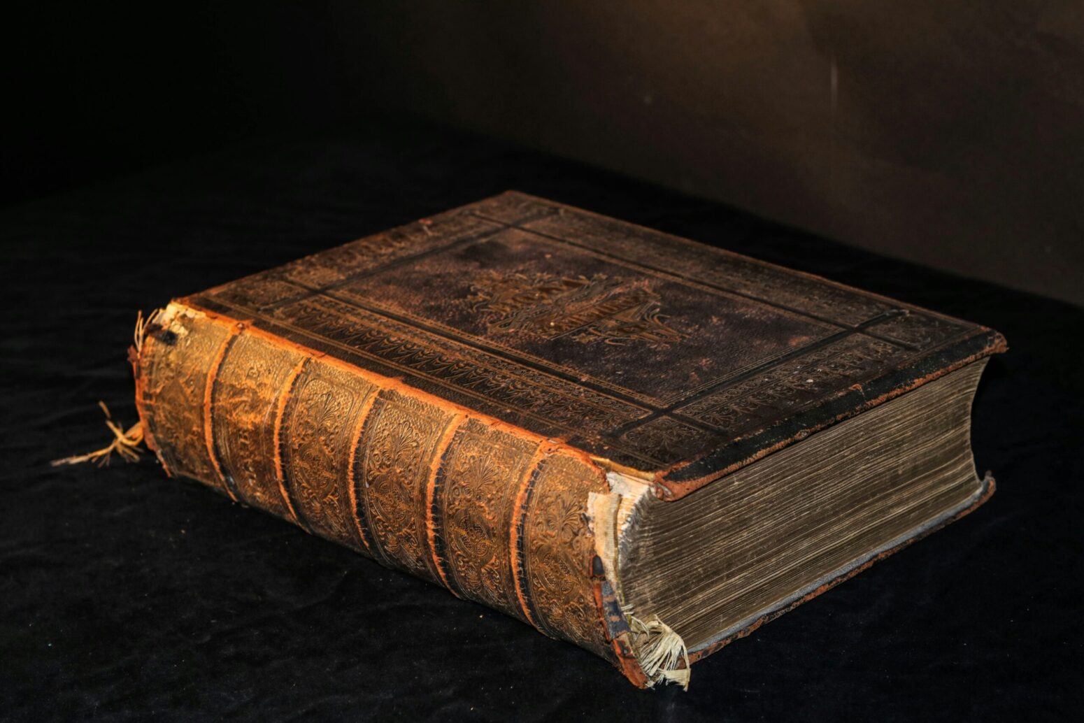 A very old, thick book with frayed binding