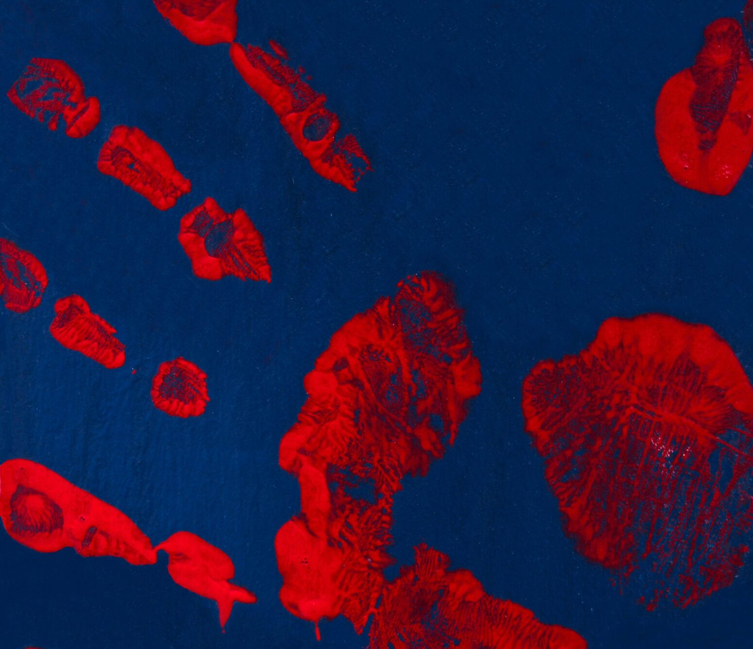 A red handprint on a dark surface