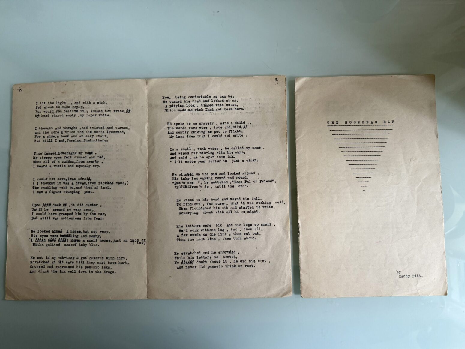 Hand-typed manuscript from the 1940s, titled, "The Moonbeam Elf." Title on right-hand page, with a series of lines underneath it tapering to a point.