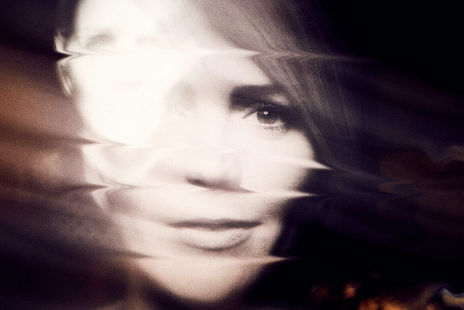 This photograph shows a blurred face of a woman.