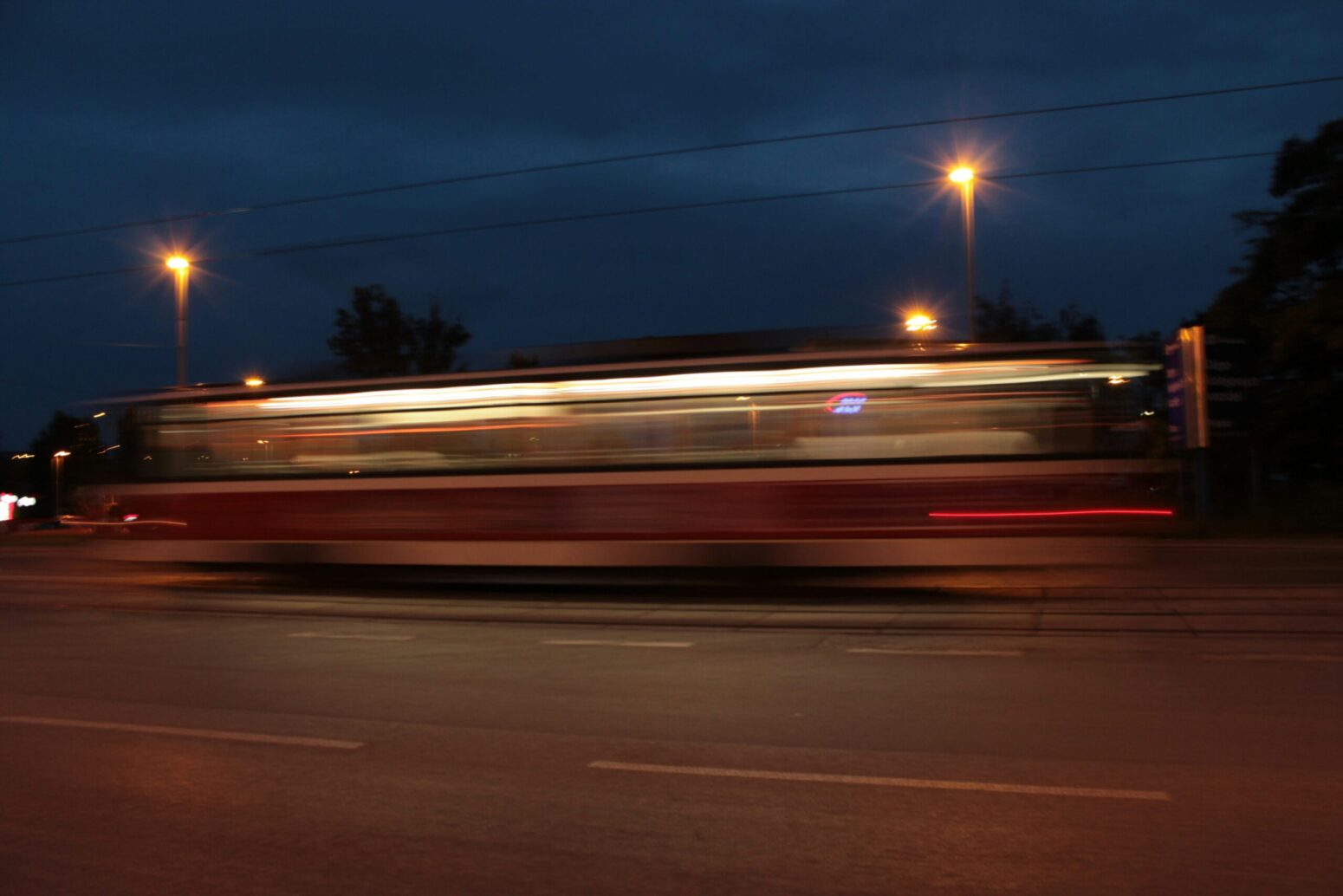 This photograph shows a vehicle, presumably a bus, passing on the road.