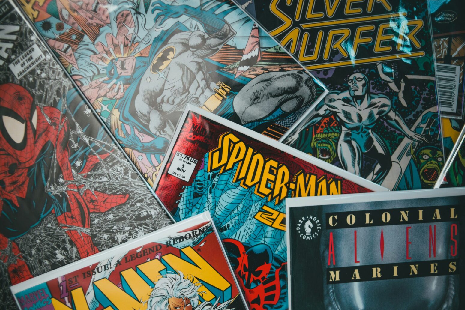 This photograph shows an array of comics, scattered across the photograph with many visible colors sticking out.