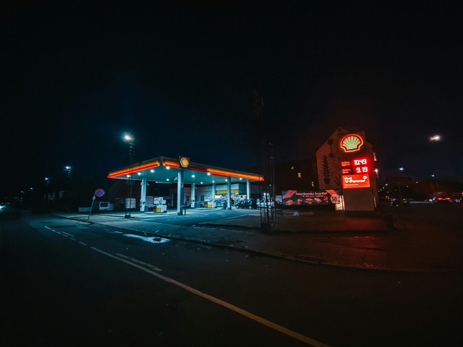 This photograph shows a gas station in the middle of the night.