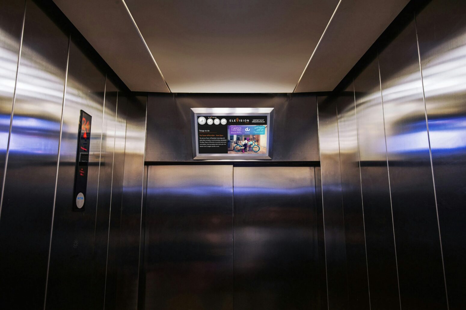 This photograph shows an elevator in operation, with the blur of the lighting and buttons visible all over the metallic walls of the elevator and in the photograph.