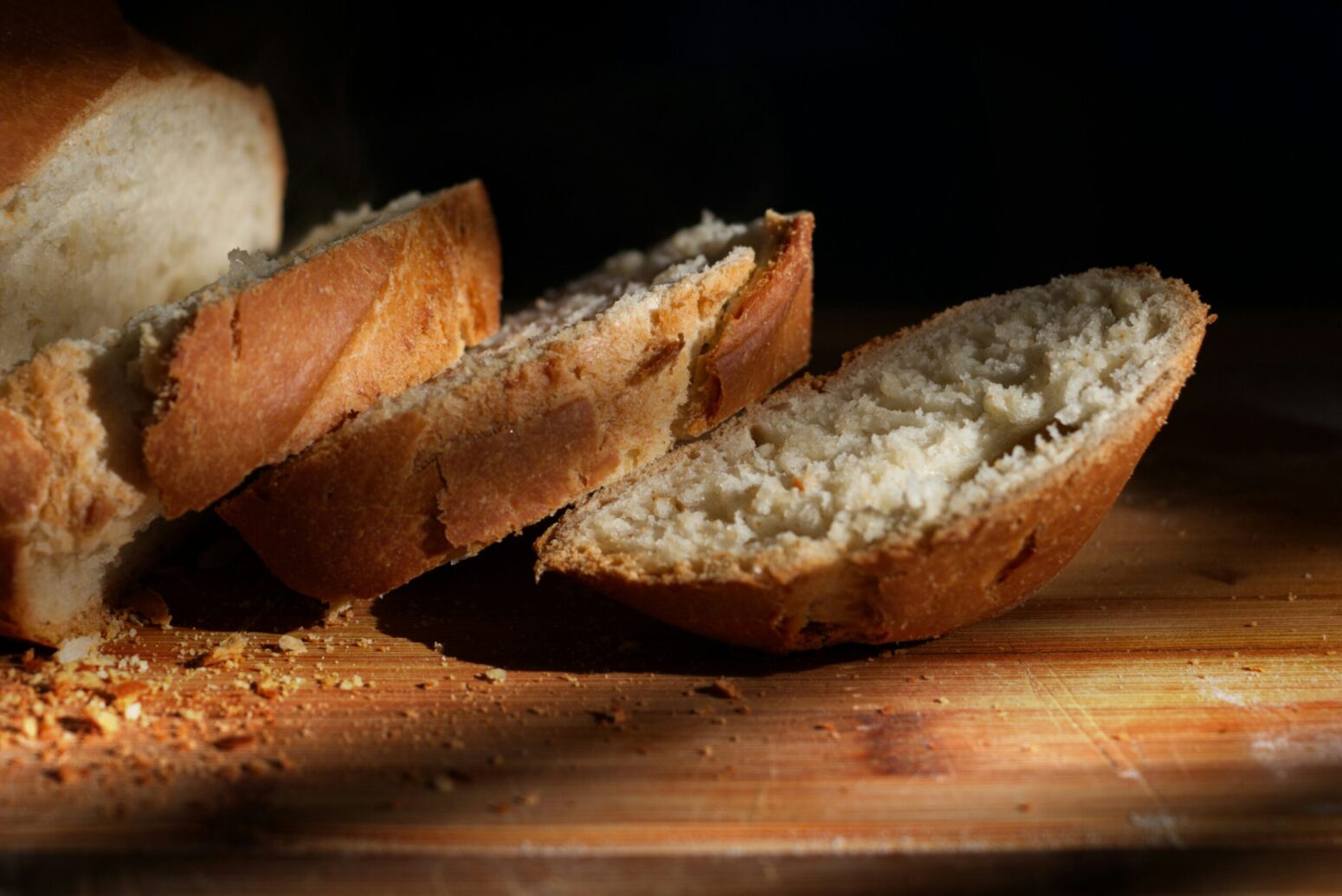 This photograph shows a loaf of bread that is sliced.