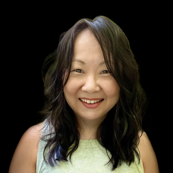 A woman with shoulder length hair smiling at the camera