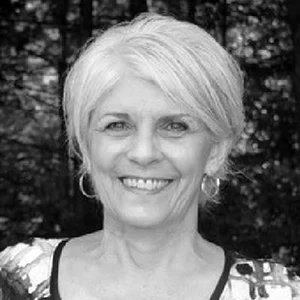 A black and white image of a woman with short white hair