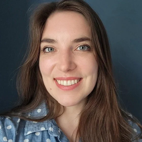 A woman with brown hair smiling at the camera
