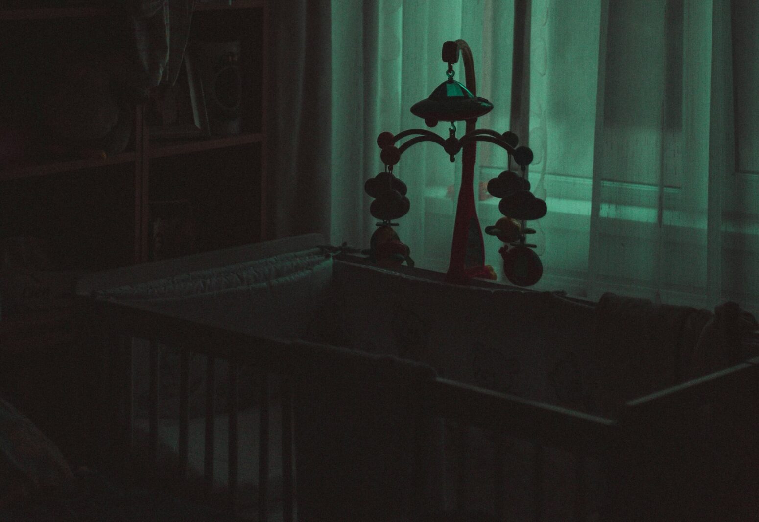A crib in a really dark room