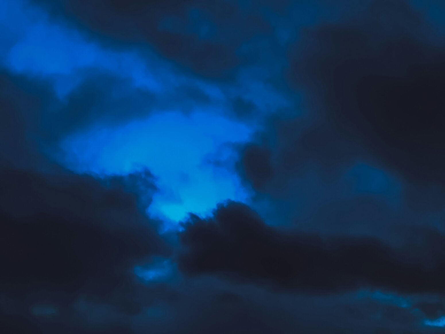 cloudy sky in a dark-utramarine blue haze