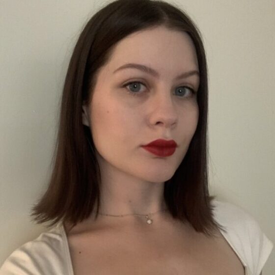 Woman with short brown hair and red lipstick
