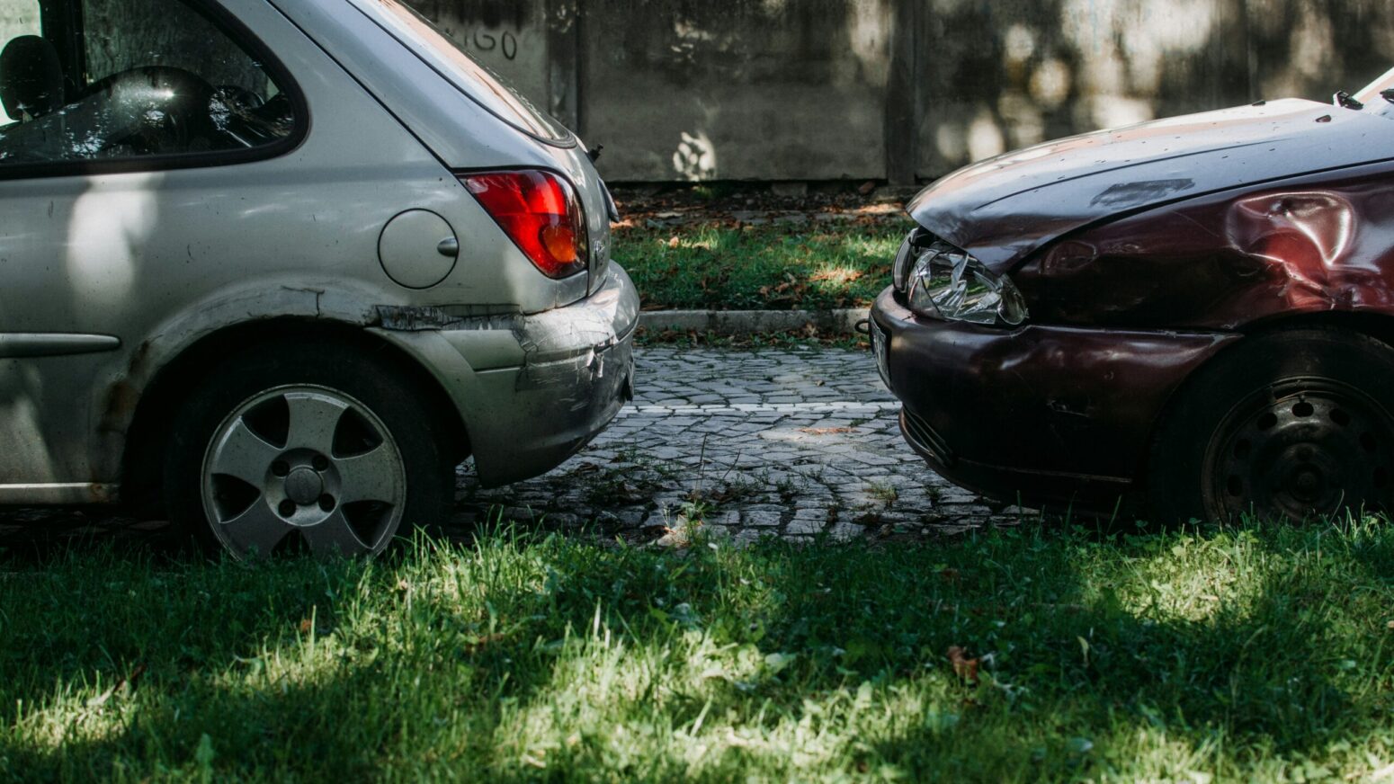 The back end of one car and the front side of another facing each other