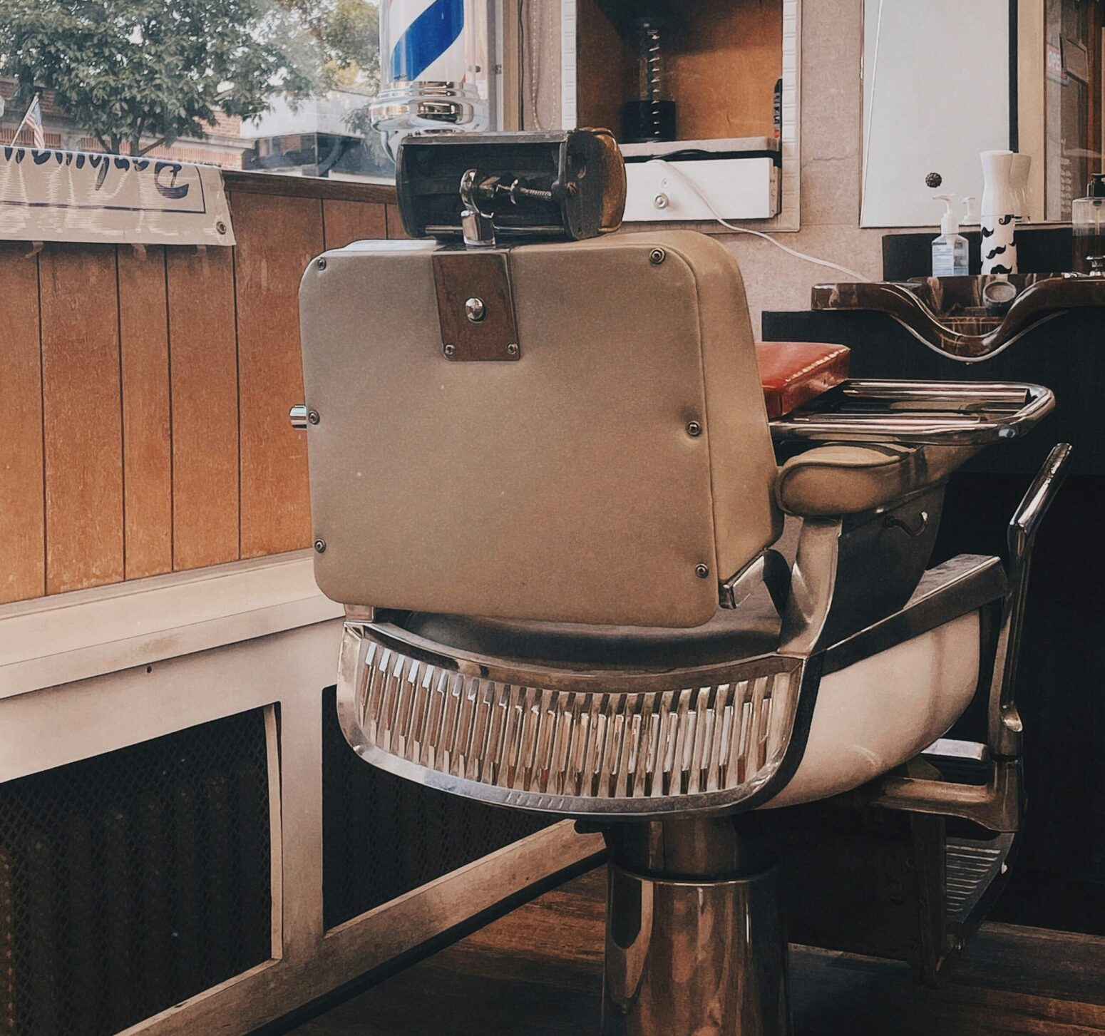 A chair in a salon facing towards the mirror