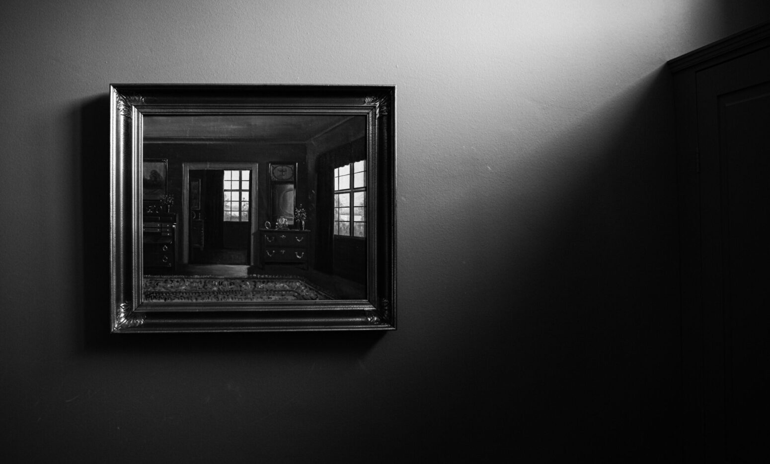 A mirror on the wall that reflects the room it is in